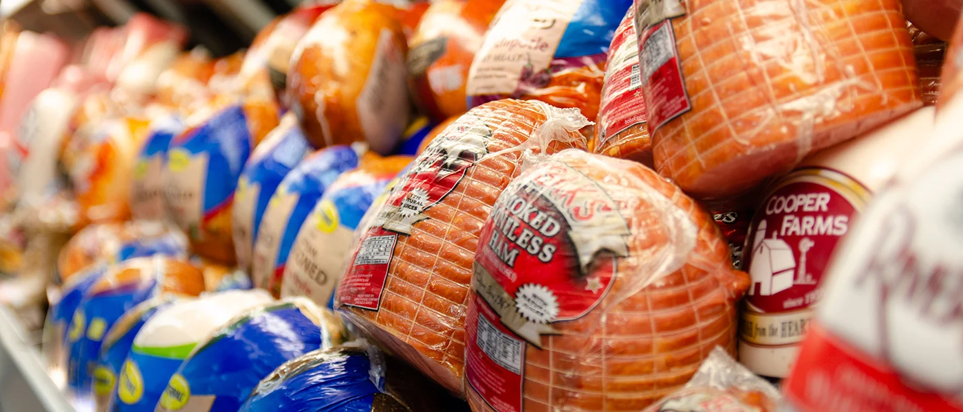 variety of fresh hams displayed at Fresh County Market